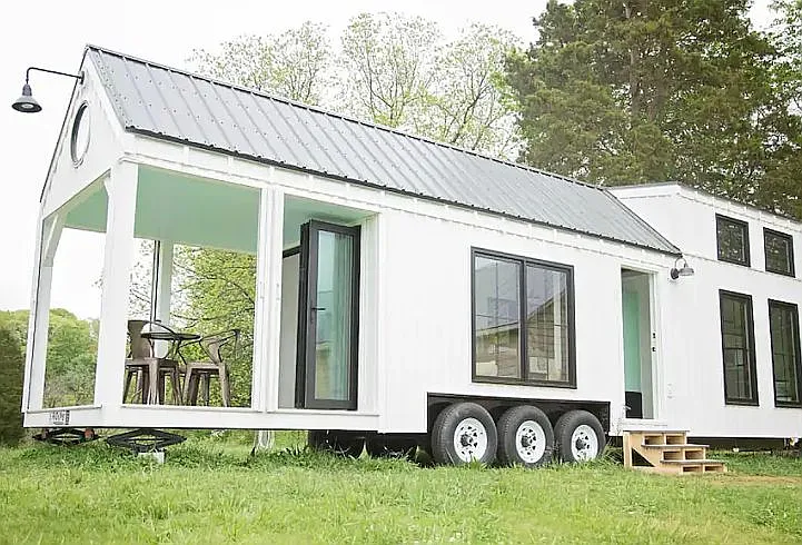 Own a piece of tiny house history in this fully furnished 36′ tiny farmhouse on wheels featured $105,000