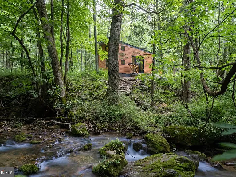 “Creekside,” is a fully functional and highly rated 312-square-foot tiny cabin with a loft. Tucked into the woods situated on 19.36 acres,
