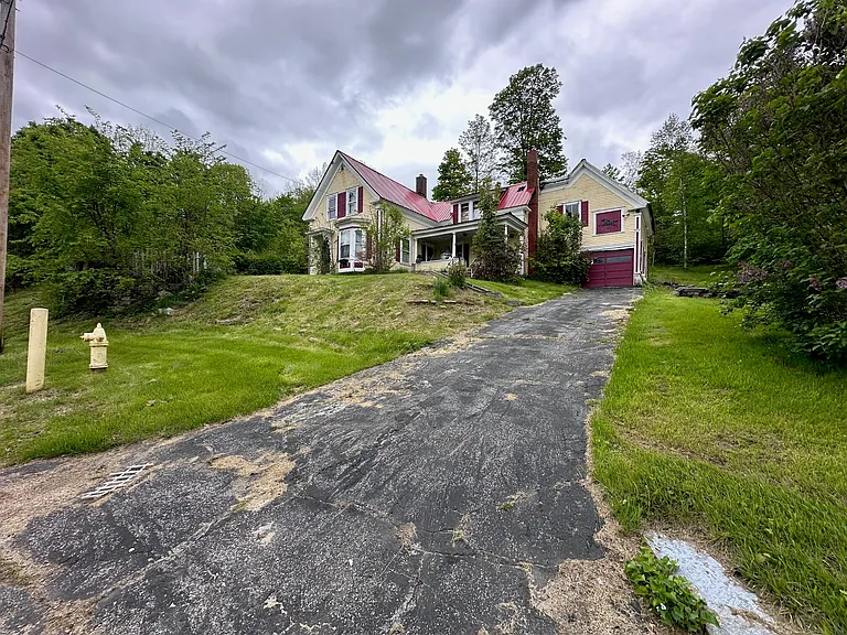 Located in town on High Street this property is nestled away with just under 5 acres of land with scenic views and sloping terrain. $64,999