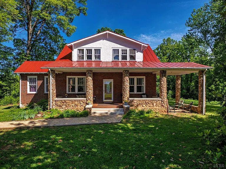Just outside of town, past the orchard, through the stone pillars sits a 1930’s brick and stone home with a red metal roof and a welcoming porch spanning the front.