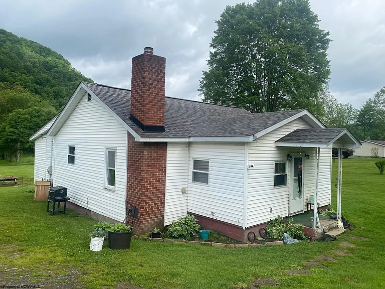 ESCAPE TO THIS CHARMING BUNGALOW WITH RIVERFRONT ACREAGE AND MOUNTAIN VIEWS NESTLED IN A PEACEFUL RURAL SETTING ON 5.08 ACRES. $115,000