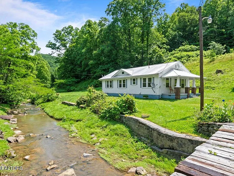 Looking for a quiet mountain home sitting creek side with a front porch, over an acre of land, and direct ATV trail access? $165,000