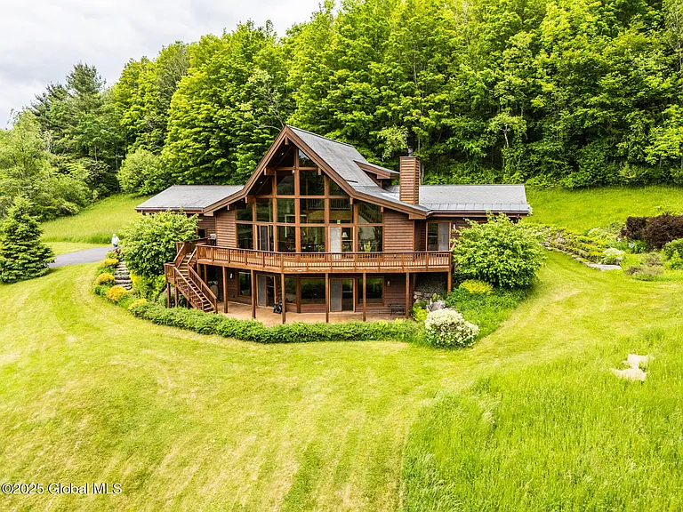 Magnificent 3 level home with expansive views of the Green Mountains on 5 private acres.