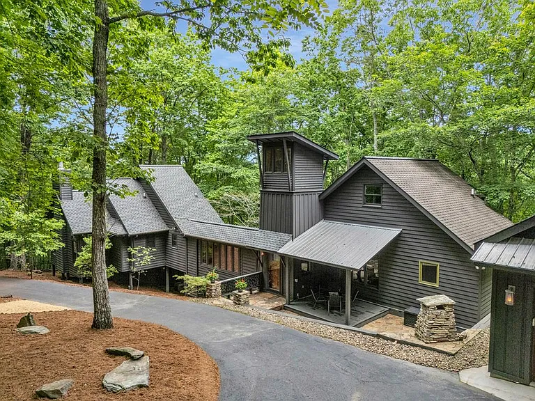 This one-of-a-kind retreat sits on 5+ acres of serene woodland offering a rare blend of unique architecture,