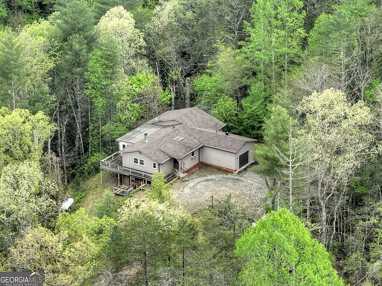 Nestled amidst 8.1 acres of serene, wooded landscape, this privately situated home offers both comfort and potential. $299,900