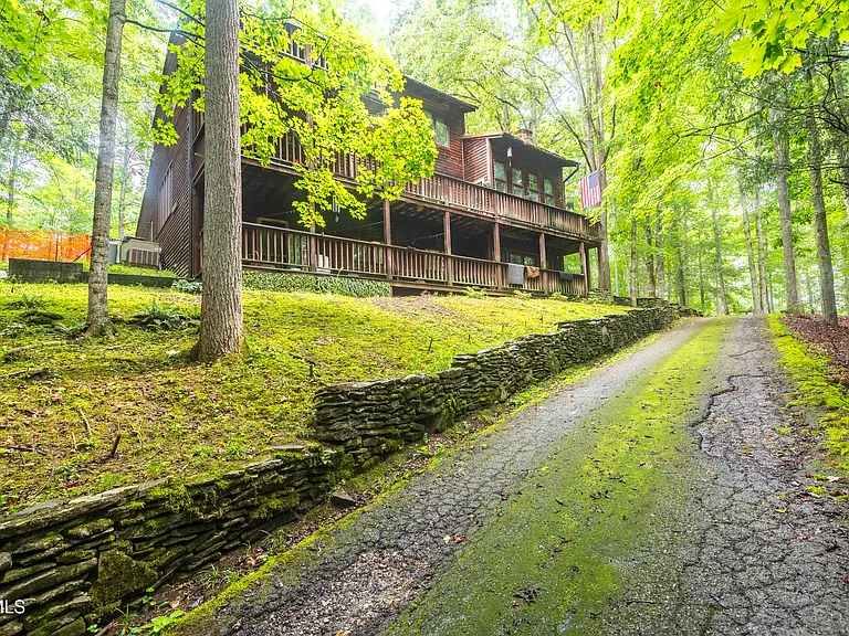 Wood siding , metal roof. 3 heat pumps . Italian tile and hardwood floors compliment this beautiful home.