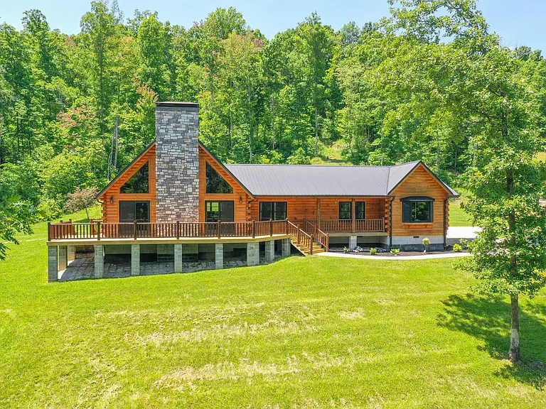 This luxury custom log home sits on 28.48 acres and features stunning views of your very own pond.