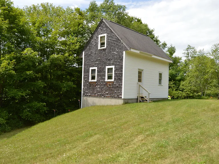 Unfinished 2 bedroom cabin located in small New England Town, large lawn area and a wooded area. $79,000