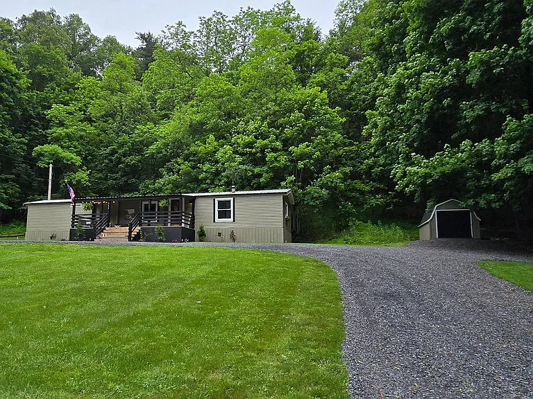 It features a 2.5 acre lot with a spacious front yard and has been beautifully landscaped. $179,900