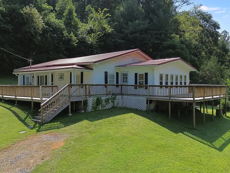 Situated beside Hwy 58 on 13 acres which has a creek and wooded acreage behind the house. $199,000
