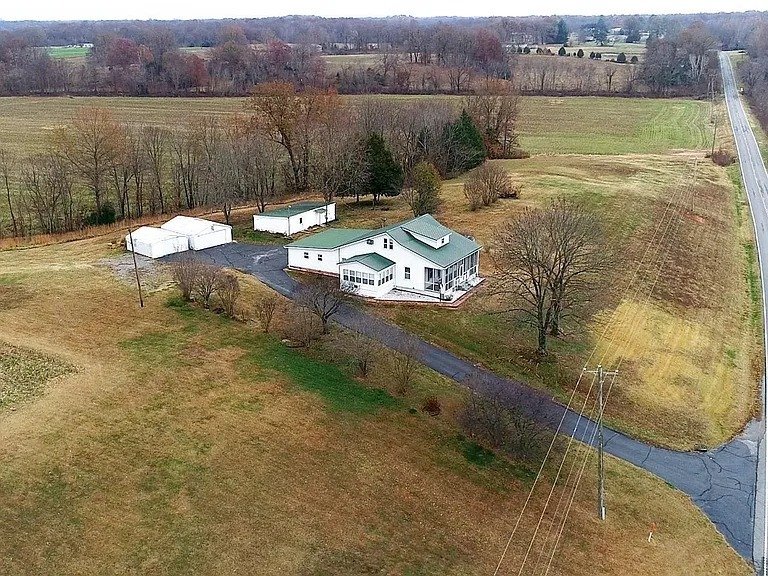 Rustic Charm Meets Endless Potential on 31 Acres – Classic Farmhouse Retreat with Barns, Garages, and Expansive Land