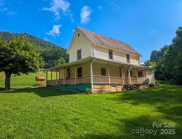Step Back in Time to 1900 — A Classic Mountain Farmhouse with Acreage in the Heart of Yancey County $215,000