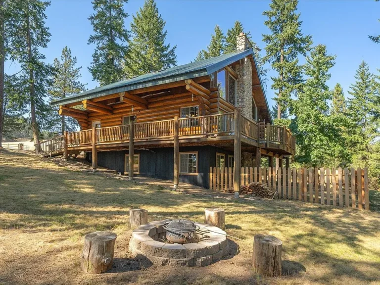 Tucked away on a secluded 5.5-acre parcel surrounded by towering evergreens and natural beauty,